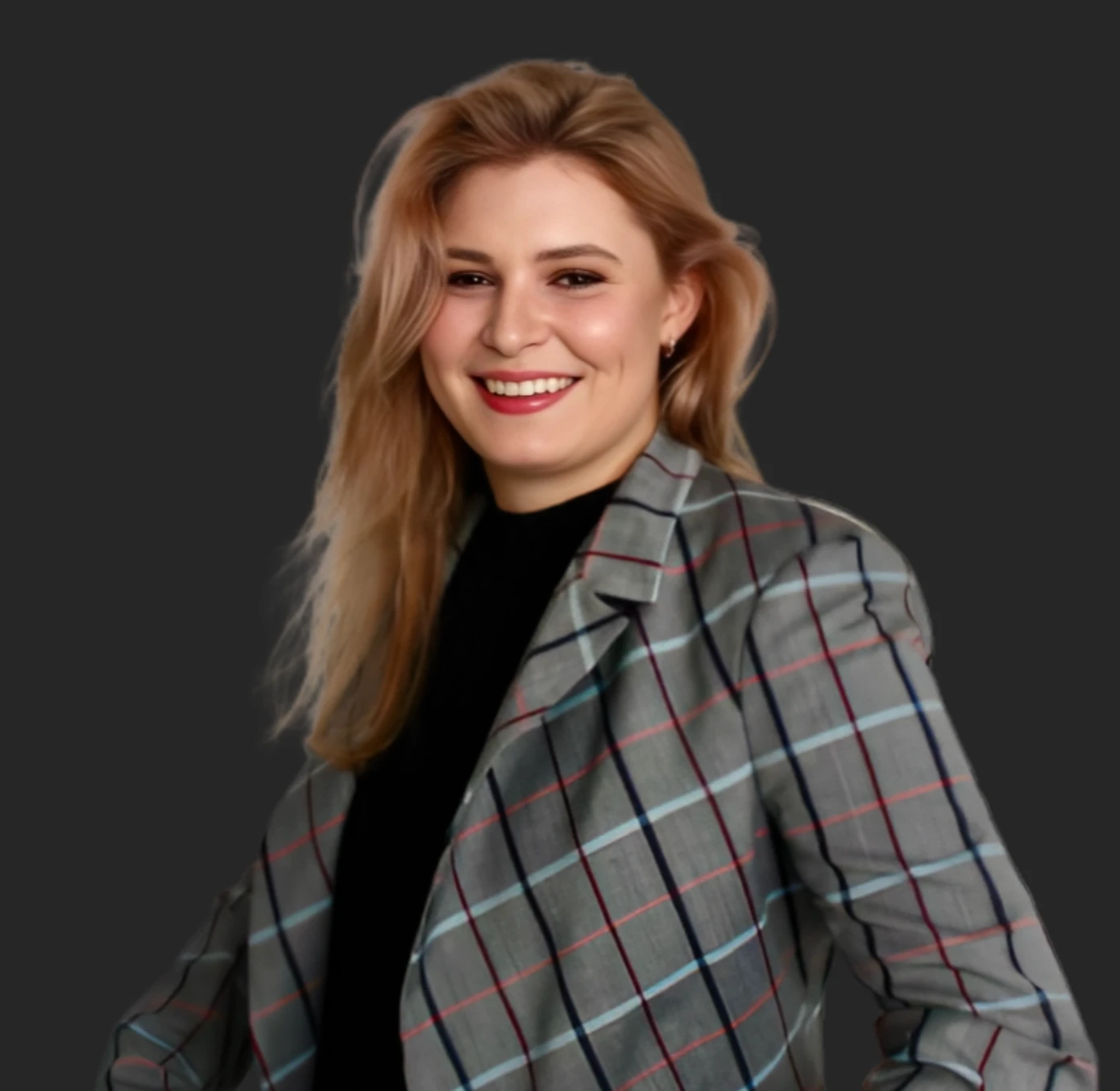 Anastasia Yushkina, founder of YDN Technologies and AI automation leader, smiling in a grey tartan blazer