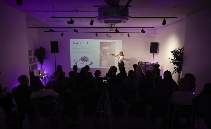 Anastasia Yushkina presenting on stage to a full room at a YDN Tech Guild event